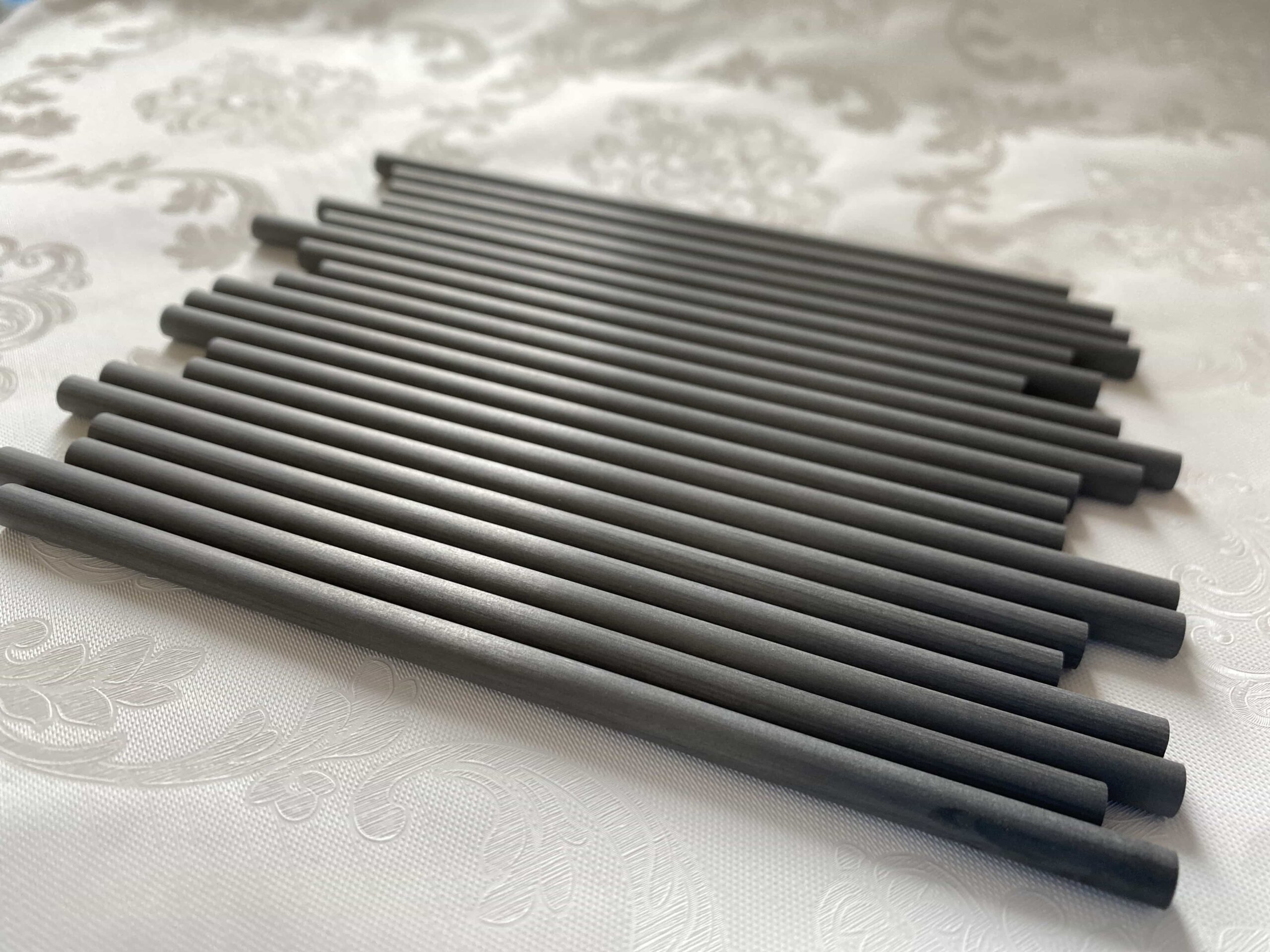 alt="close-up of carbon fiber tube with tight twist angle tolerance"