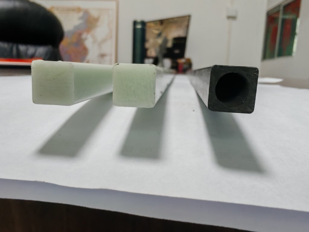 alt="comparison of roll-wrapped and pultruded square carbon fiber tubes"