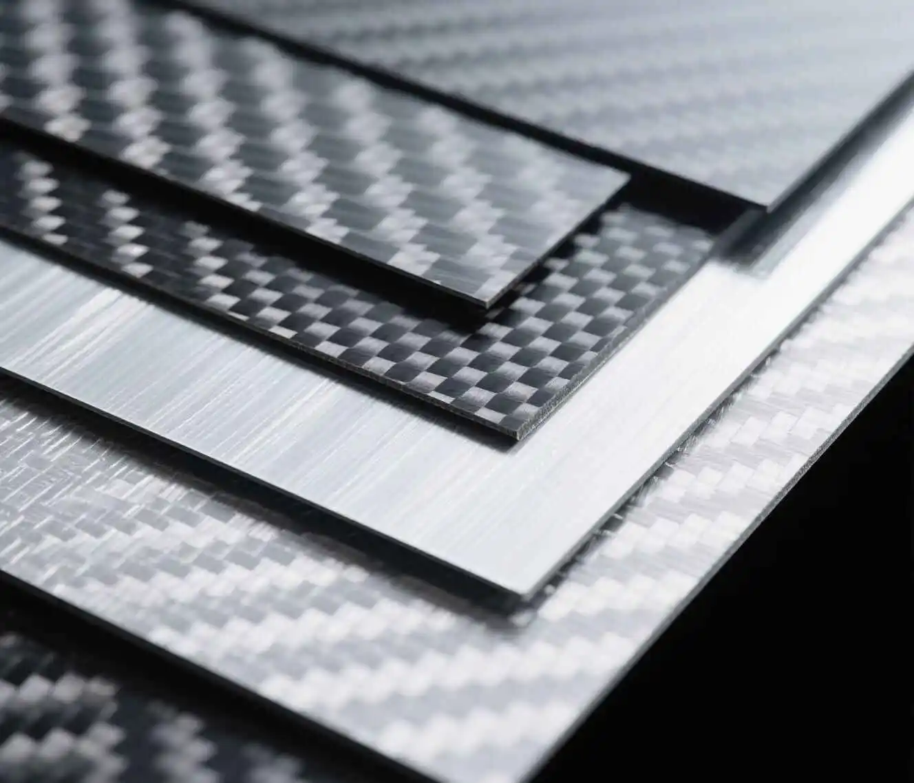 alt="Various types of real carbon fiber sheets including raw and laminated"