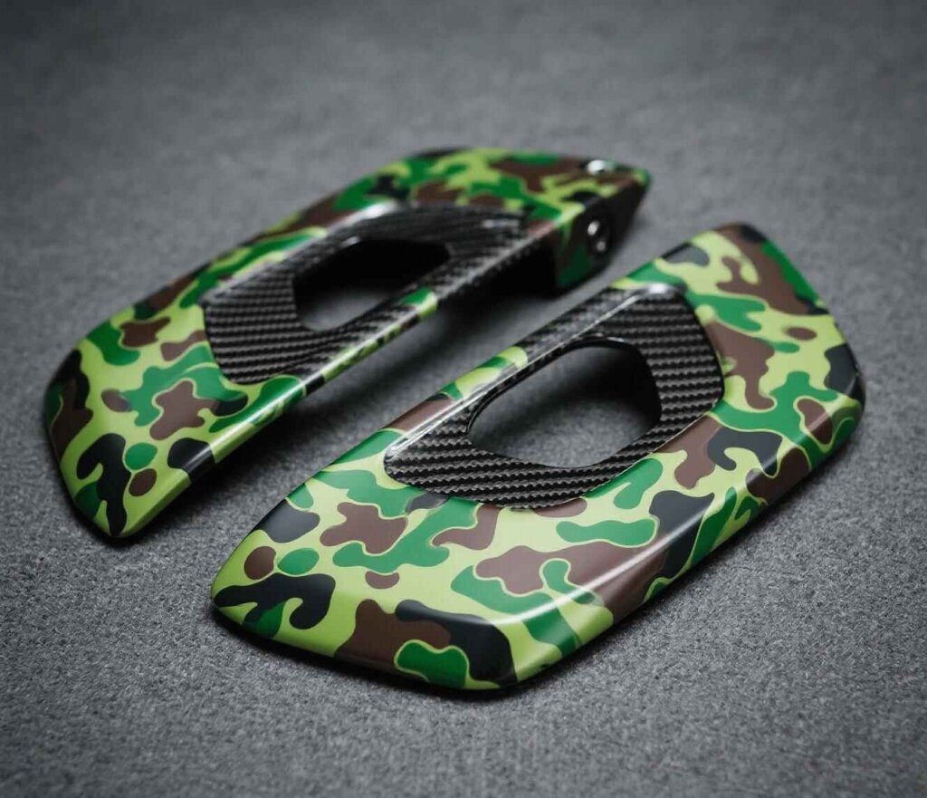 alt="Hydro-dipped carbon fiber custom parts with camo pattern"