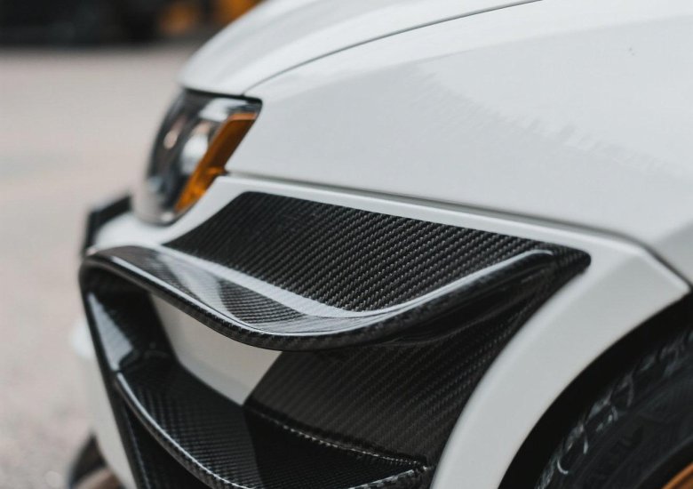 alt="Carbon fiber adhesive sheet applied to car splitter"
