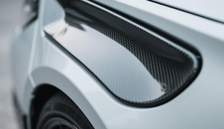 alt="Carbon fiber board sheet cut into structural seat panel"