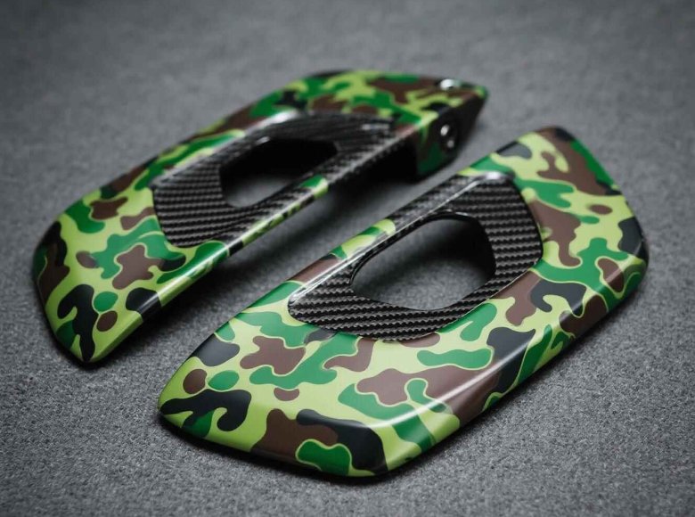 alt="Hydro-dipped carbon fiber custom parts with camo pattern"